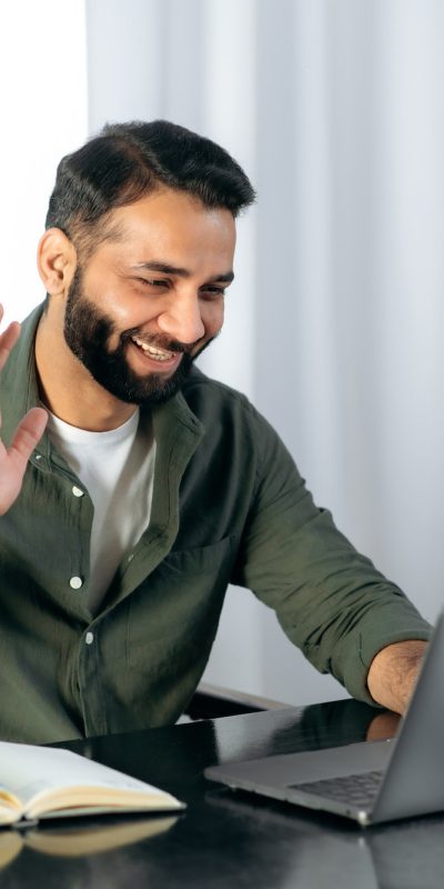 pleasant-friendly-indian-guy-manager-or-financial-consultant-communicates-with-colleagues-on-a.jpg